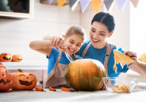 Mother and daughter carving a pumpkin after picking one from a pumpkin patch in Davenport IA