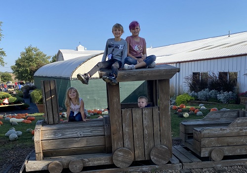 Kids pose at the Back 40 Fun Acres at Tanners Orchard, which is one of the best Apple Orchards near Morton IL
