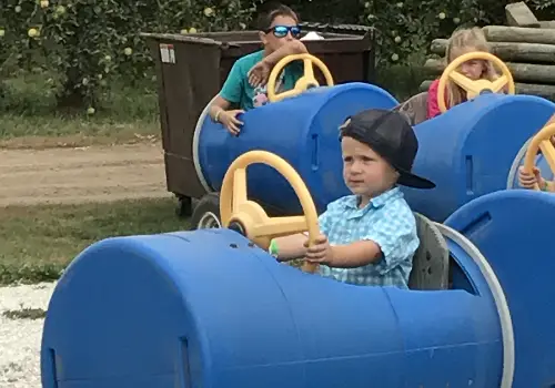 Tanners Orchard offers the Best Apple Picking by Bloomington IL, plus barrel cars to play in and more