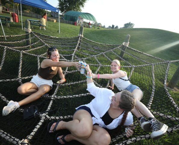 A group of women lounging in the Back 40 Fun Acres and having a drink during a special seasonal event at Tanners Orchard