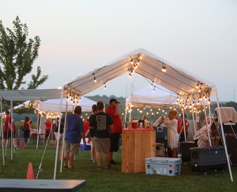 A group of people getting served drinks at one of Tanners Orchard’s many seasonal events